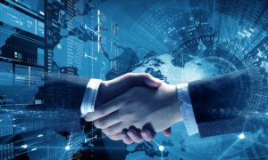 Close up of business handshake on digital technology background