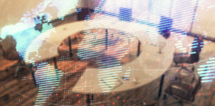 Double exposure of globe hologram on conference room background. Concept of international business